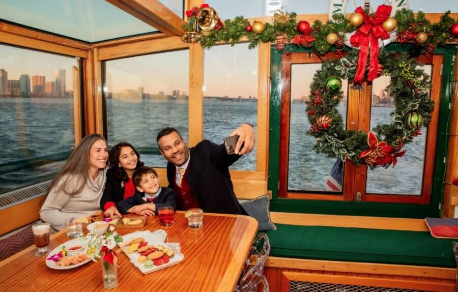 NYC: Holiday Yacht Cruise with Jazz, Cocoa & Carols - The Statue of Liberty and Ellis Island after dark